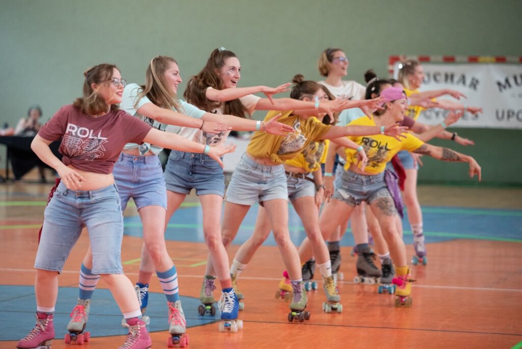 A group of flintas perform on track on rollerskates